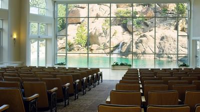 The Pavilion meeting with neatly arranged chairs facing a large glass window at The Stanley Hotel