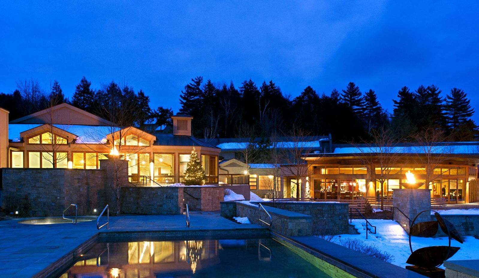 Exterior view of Topnotch Stowe Resort with pool at night