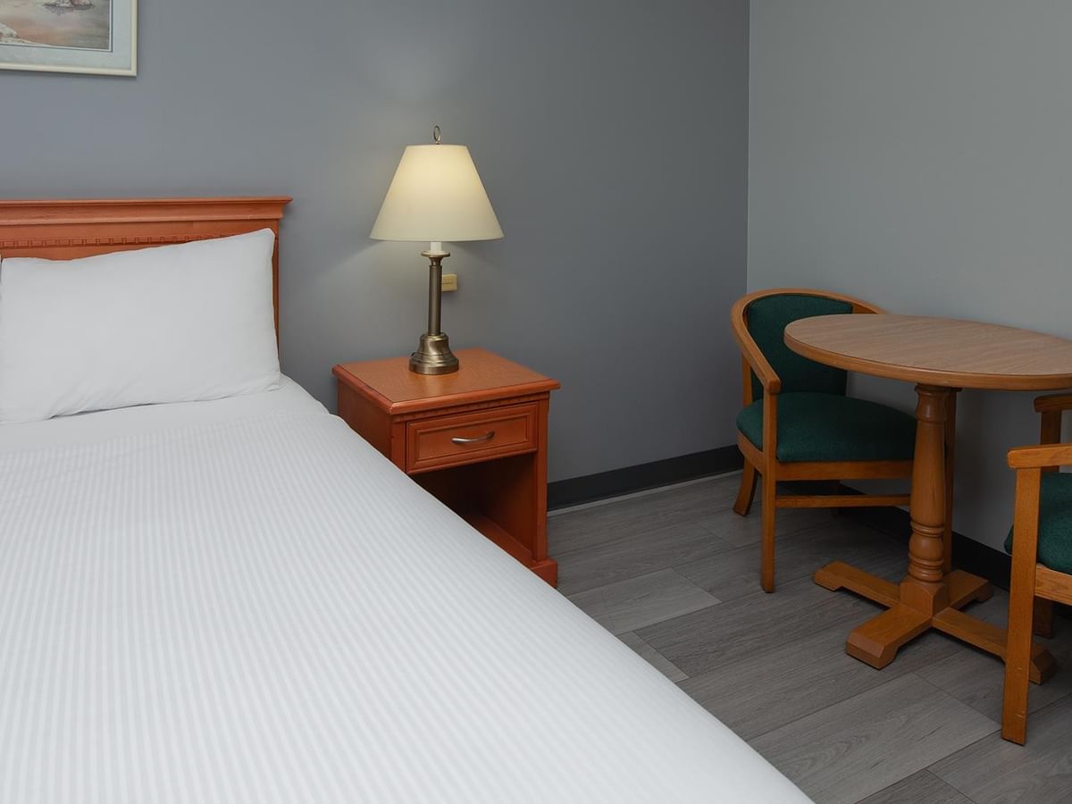 Coast Queen Pet Friendly room with queen bed and wooden furniture.