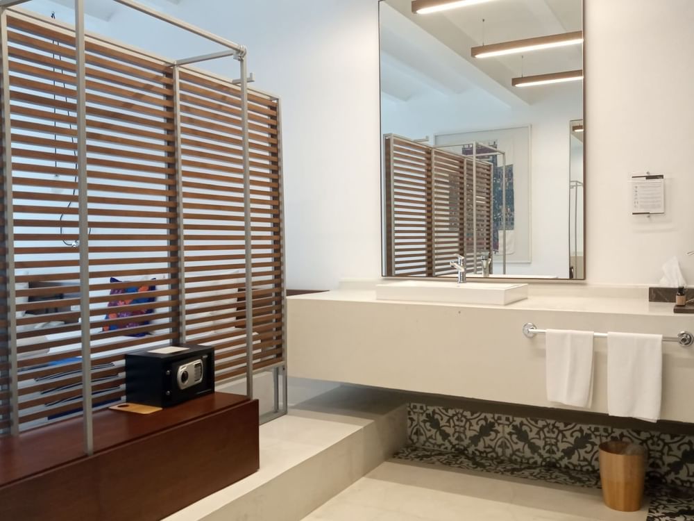 Bathroom vanity by the bed in a room at Huayacán Cuernavaca Curamoria Collection