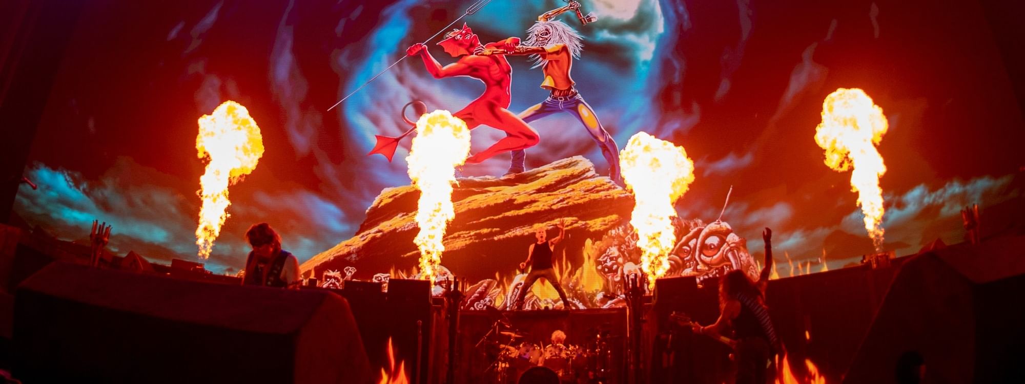 Dramatic stage performance with towering pyrotechnics and illuminated mascot figure during Iron Maiden Run For Your Lives World Tour 2026