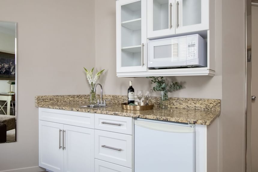 kitchenette with wine near the sink and microwave