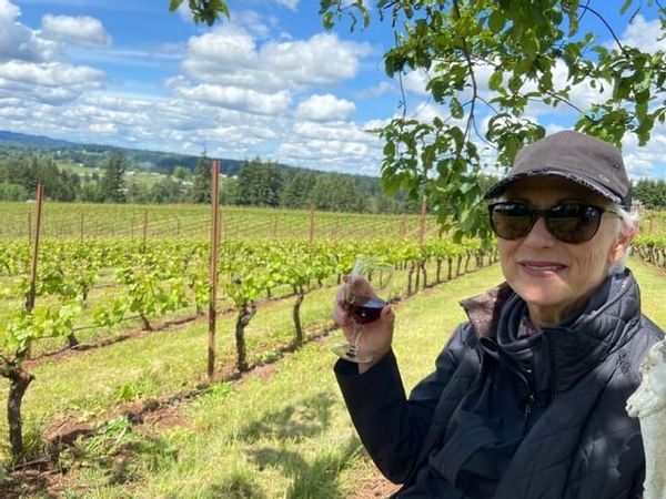Guest enjoying wine in the vineyard