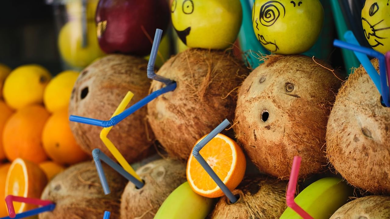 Fruit stand with coconuts, oranges, and banana
