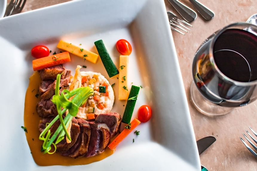 Close-up of meals served with wine at Southern Palms Beach Club