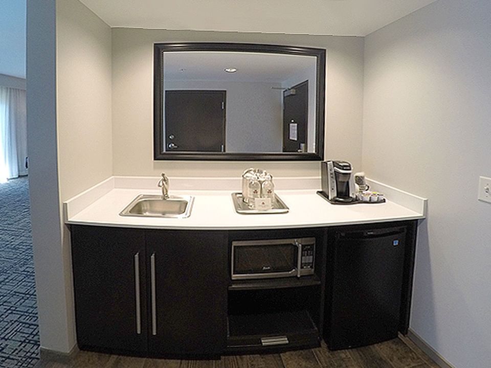 Kitchenette with a mini fridge & coffee maker in King Studio Balcony at Shangri-La Monkey Island