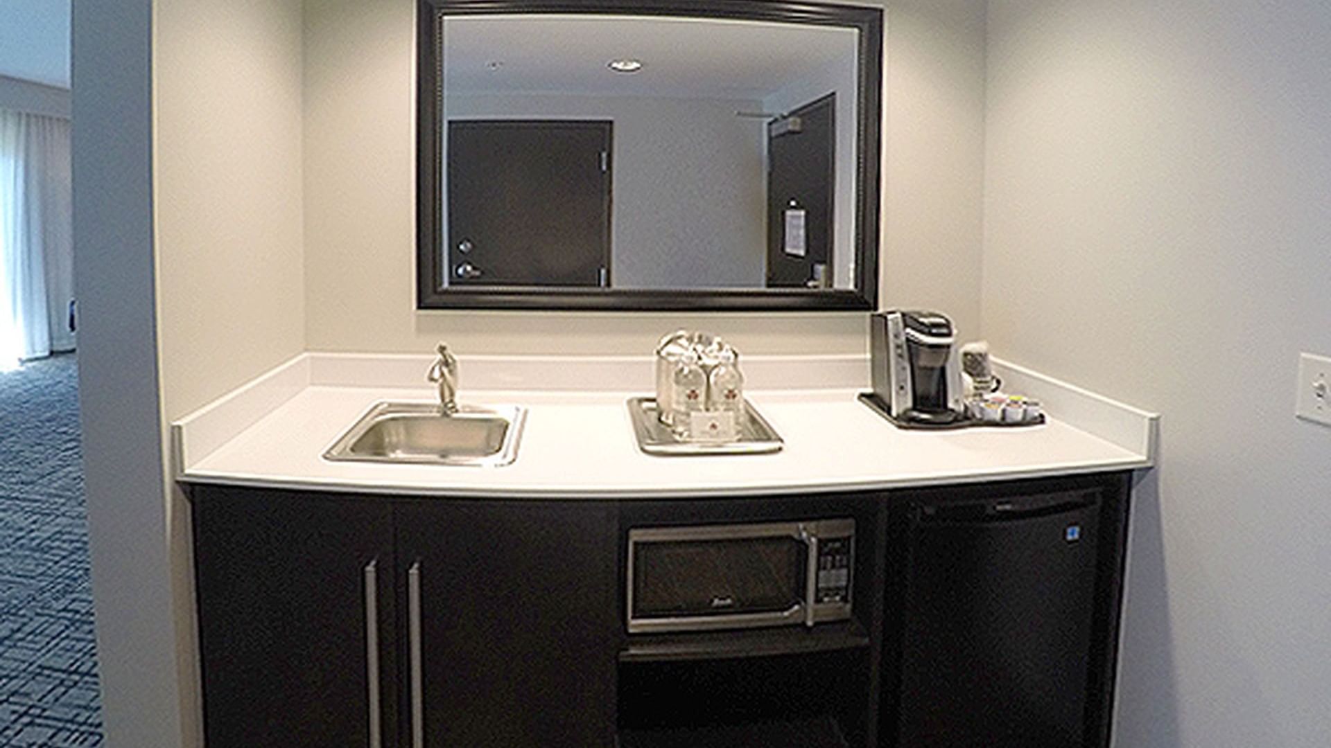 Kitchenette with a mini fridge & coffee maker in King Studio Balcony Balcony at Shangri-La Monkey Island