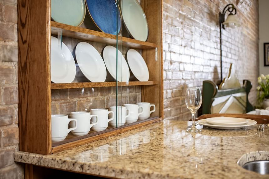 Glassware in kitchen cabinet in King Superior Home Suite Home at Retro Suites Hotel