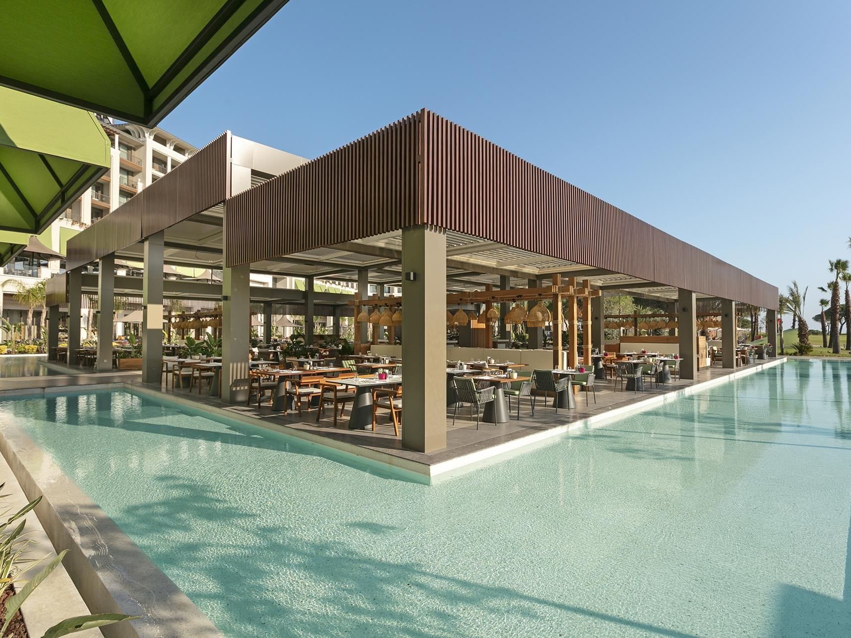 Exterior view of Mare Main Restaurant by pool area at Cullinan Belek