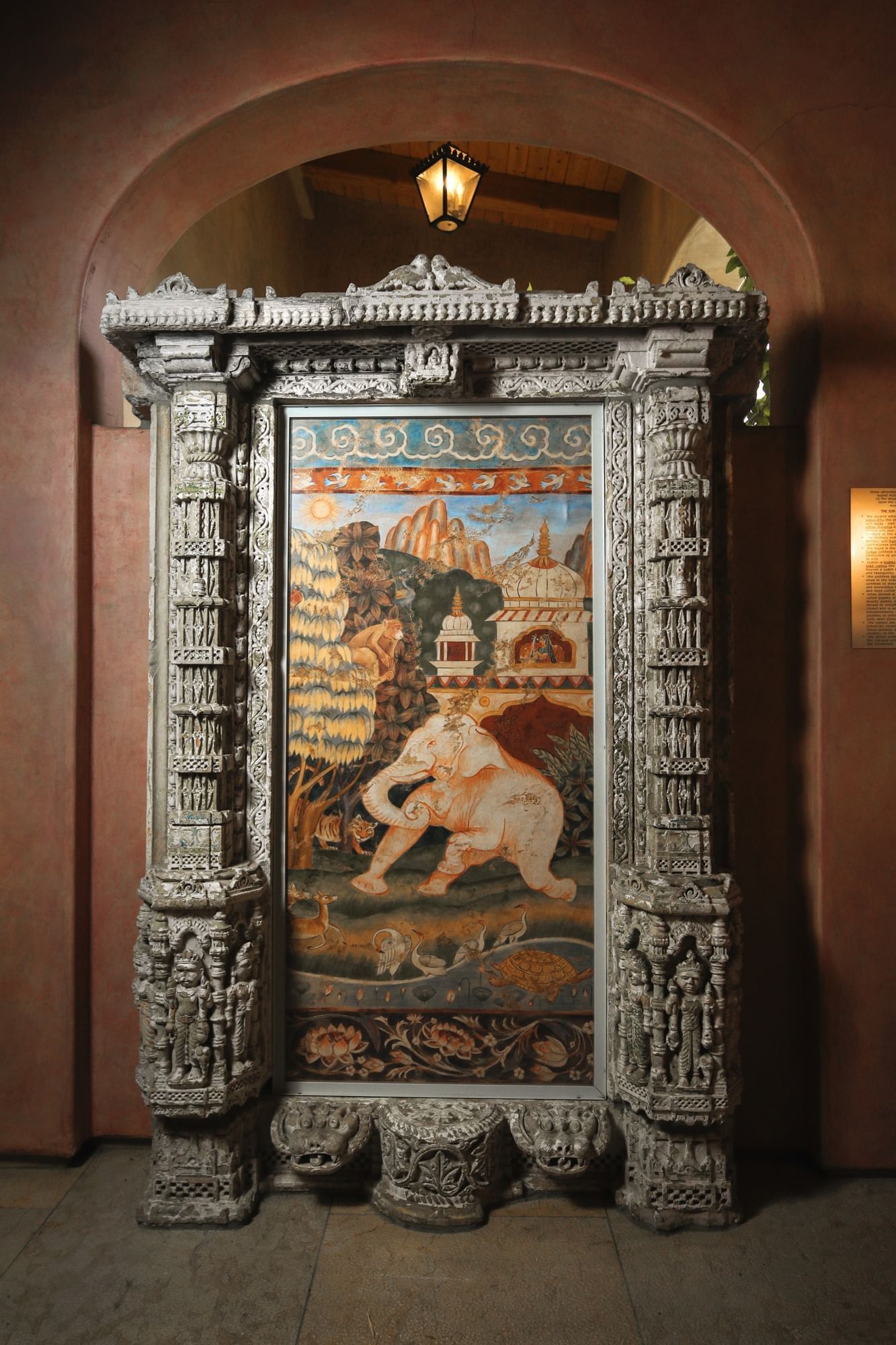 Lorem ipsum Elephant art piece surrounded by detailed carved wood