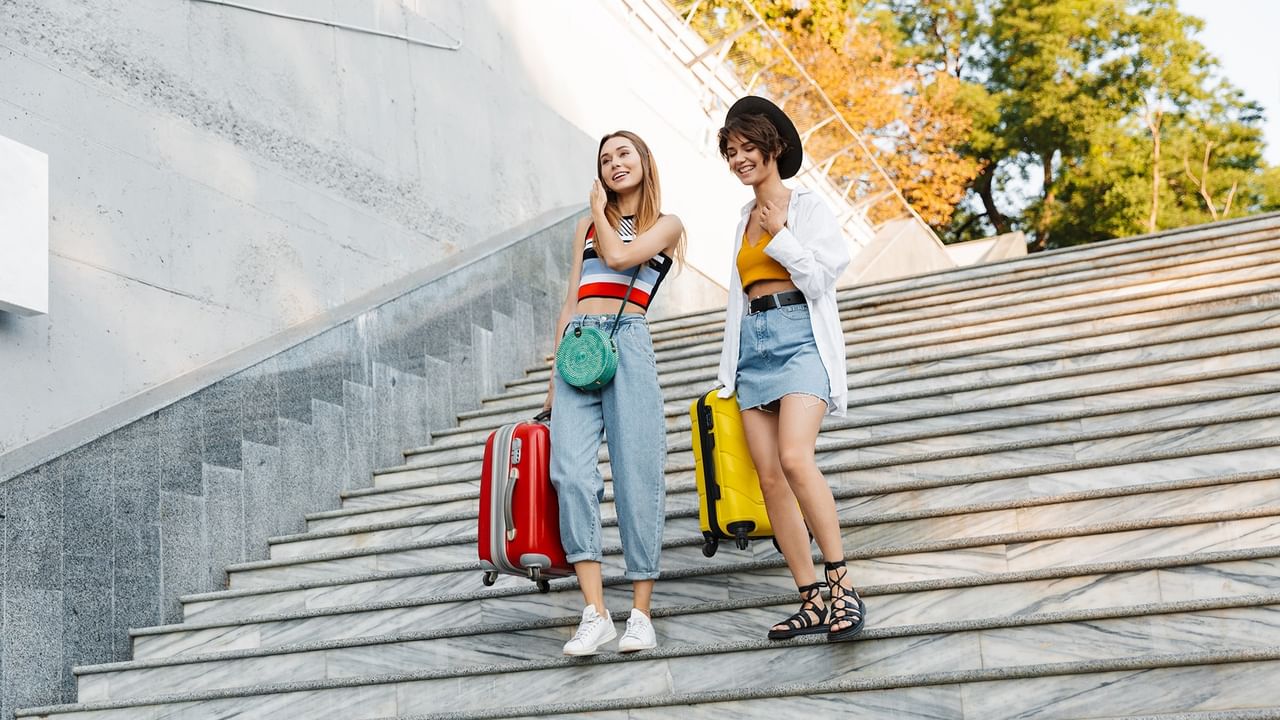 two women traveling with luggage in Calgary city