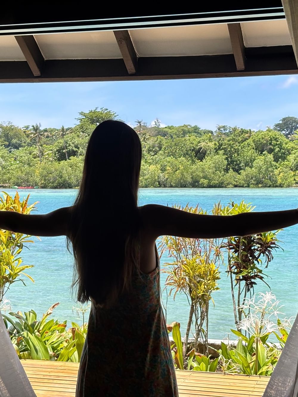Woman enjoying a view from her Pacific Pool Villa at Warwick Le Lagon - Vanuatu in Efate.