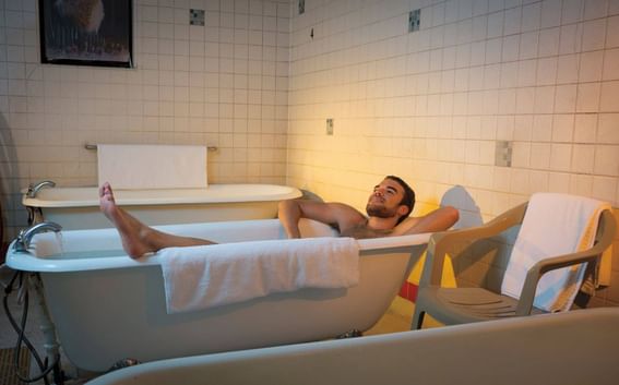 A man enjoying a bath in a tub at Carson Hot Springs Resort