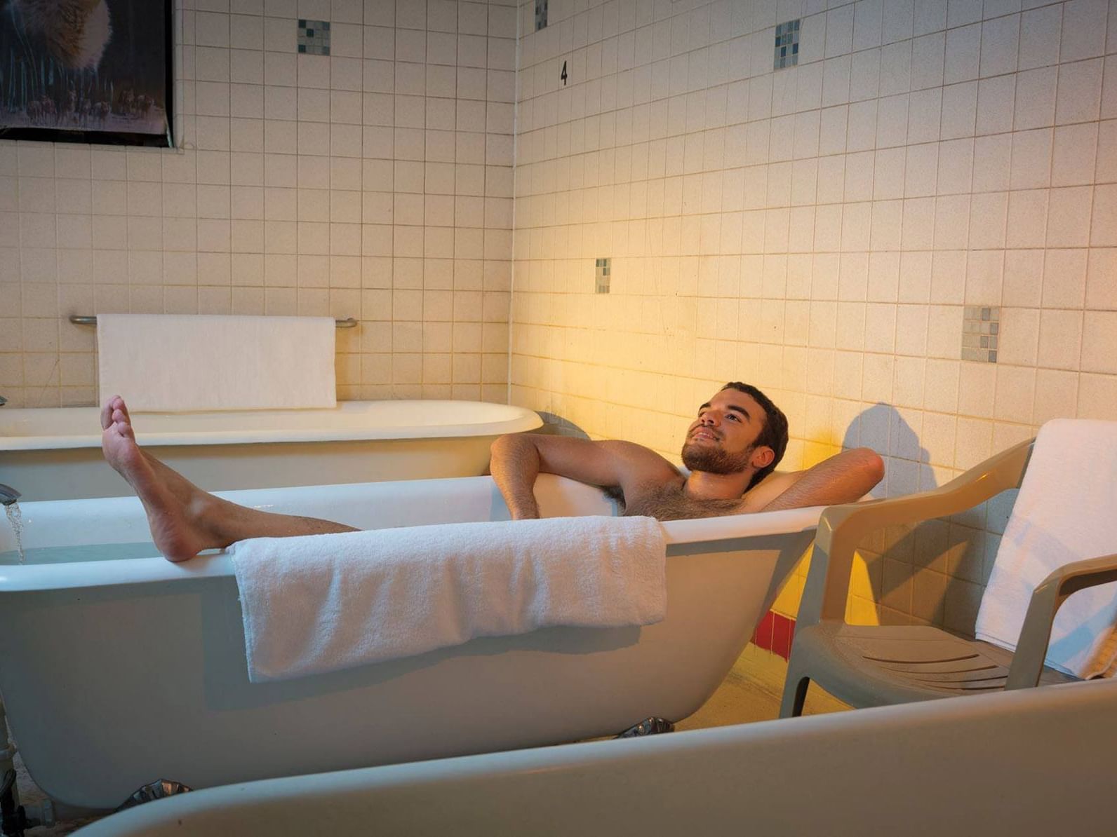 A man having relaxed bath in a tub at Carson Hot Springs Resort