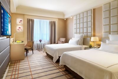 TV stand & work desk facing twin beds in Executive Deluxe with carpeted floors, A One World Hotel room