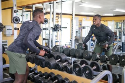 A guy by a Dumbbell rack in the gym at Holiday Inn Montego Bay