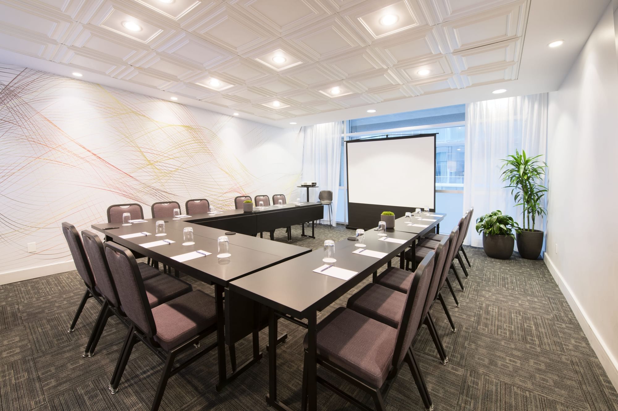 Salon Stanley with u-shaped table setup and a screen at Warwick Le Crystal