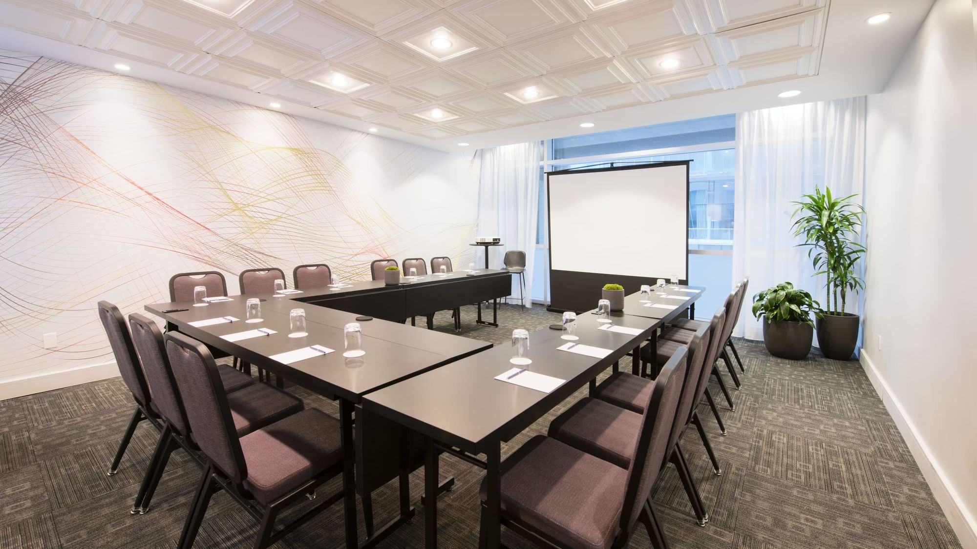 Salon Stanley with u-shaped table setup and a screen at Warwick Le Crystal