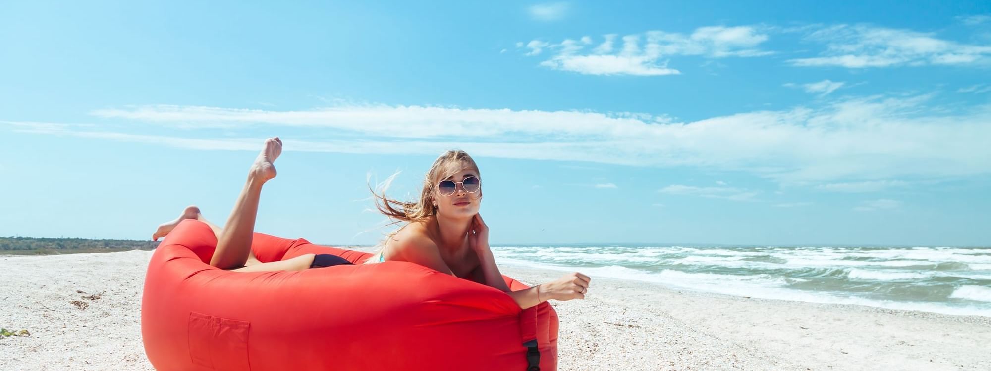 Woman sun bathing on the beach at Daydream Island Resort