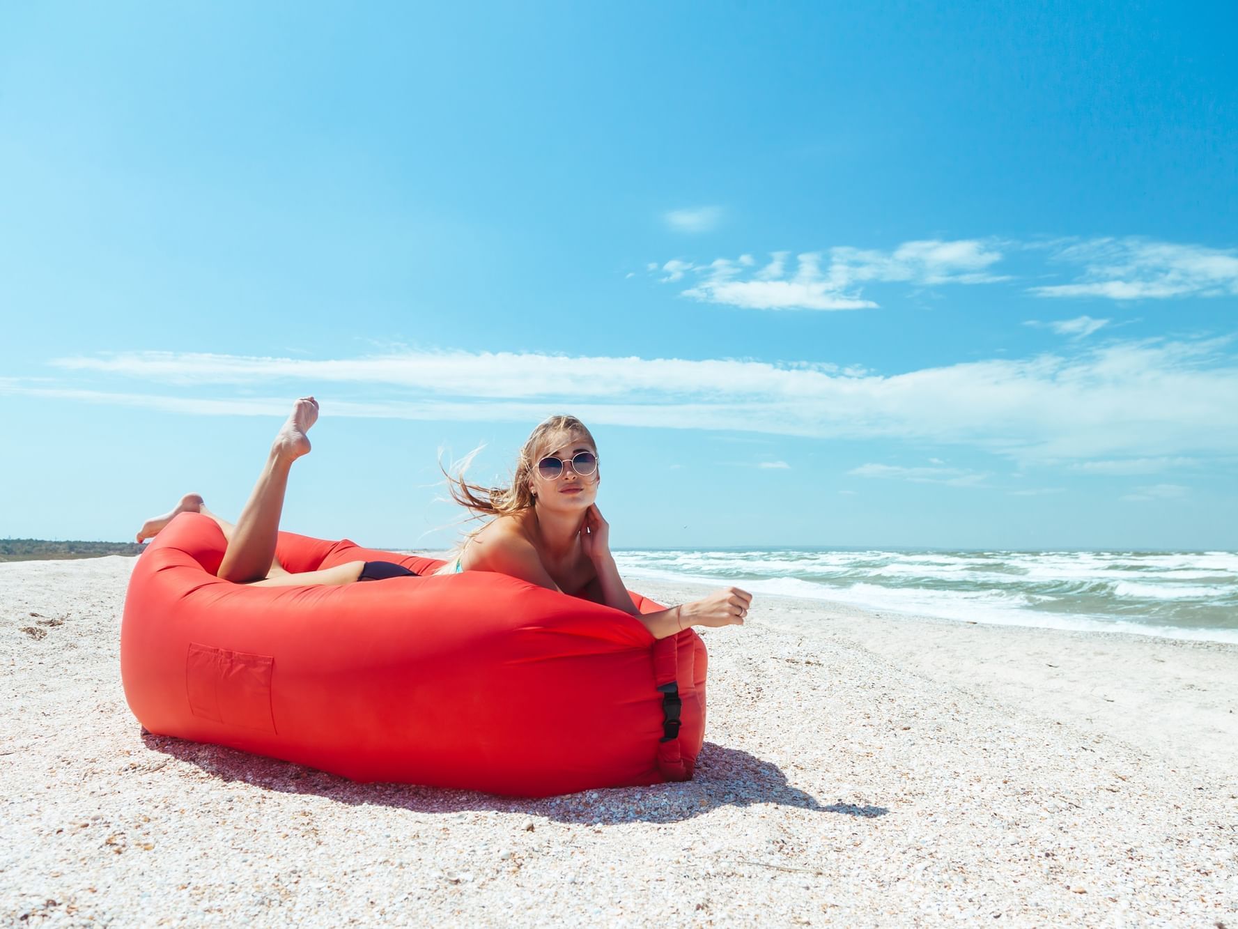 Woman sun bathing on beach at Daydream Island Resort