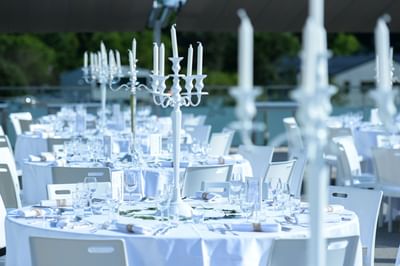 White-themed dining table elegantly arranged for an outdoor wedding at Starling Hotel Lausanne