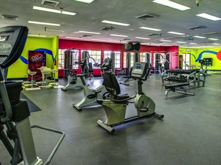 a well-equipped gym with various exercise machines and free weights
