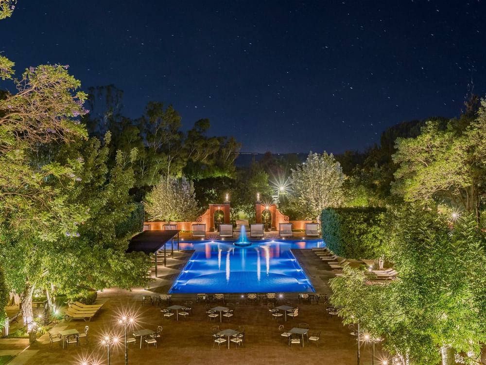 Outdoor pool with night lights at FA Hotels & Resorts