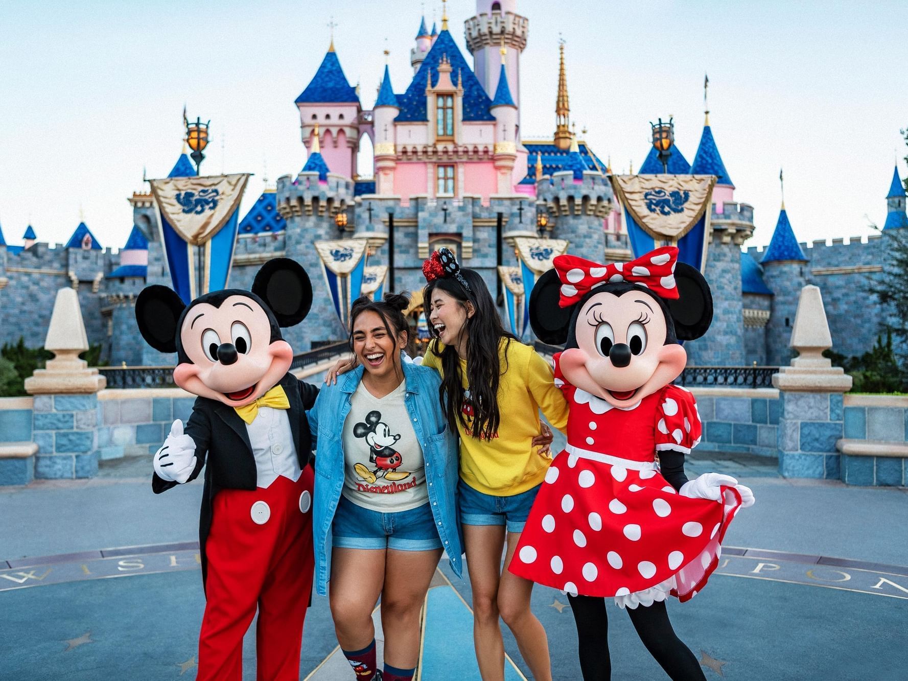 Two ladies posing with Mickey & Mini mouse at Disneyland near Anaheim Portofino Inn & Suites