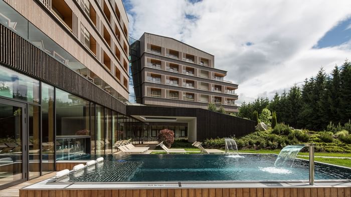 Exterior view of Falkensteiner Hotel Schladming, featuring outdoor pool area