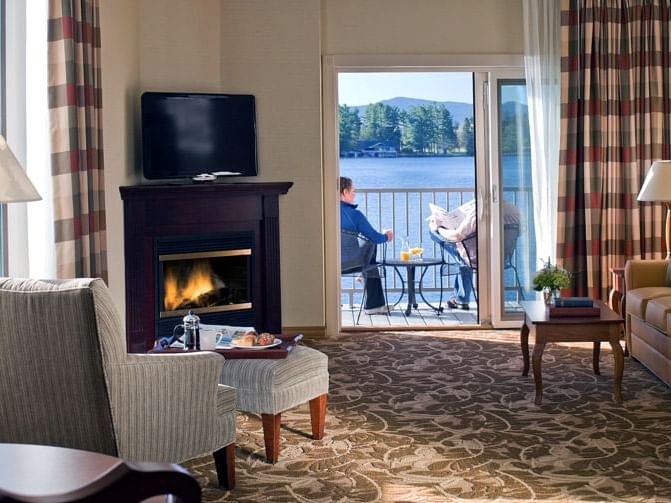 A man at the Waterfront suite's balcony in High Peaks Resort