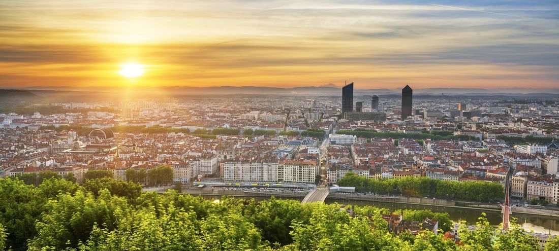 Panoramic golden sunset view over the Lyon city skyline from the Warwick Reine Astrid - Lyon