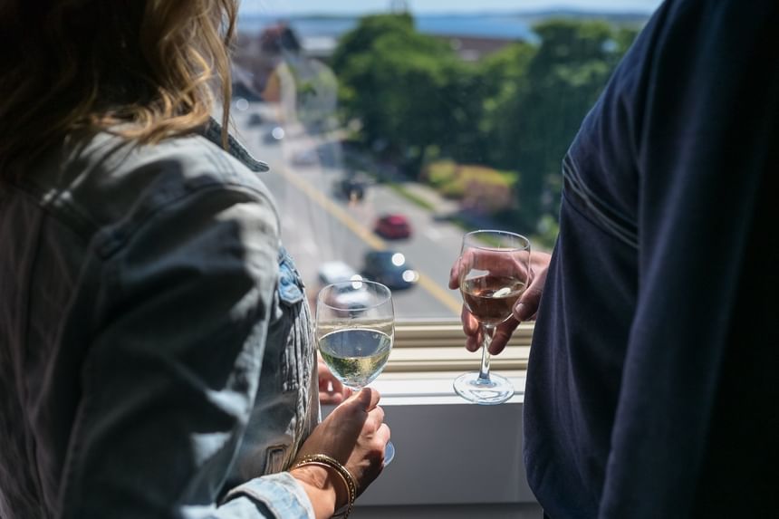 Couple enjoying wine with scenic views at Rodd Grand Yarmouth, one of the best hotels in Yarmouth for getaways