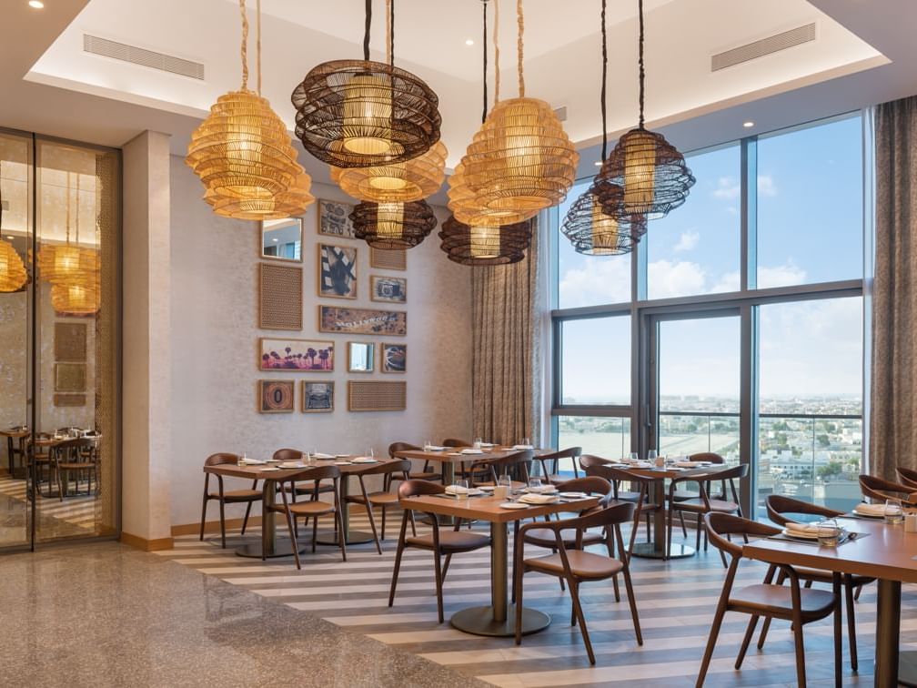 Dining tables arranged in Cinescope Restaurant at Paramount Hotel Midtown