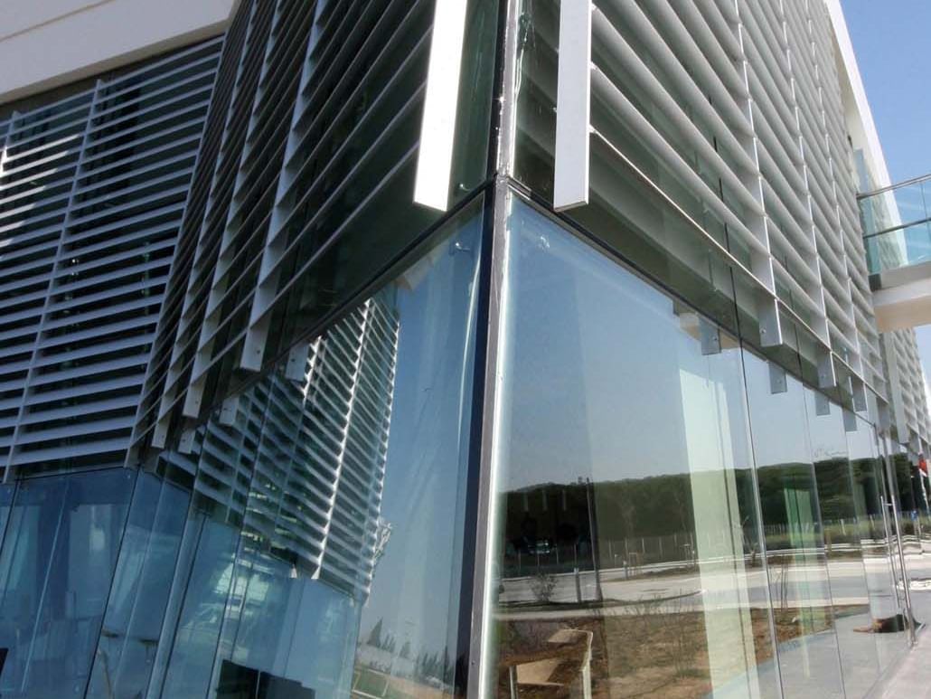 Close-up exterior of building corner with reflective glass at Titanic Anadolu Gebze