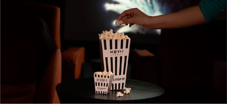Fresh popcorn served in striped movie lounge boxes ready for an indulgent private cinema night at DAMAC Maison Aykon City