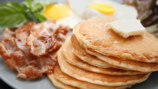 Close-up of breakfast pancakes and bacon at Warwick San Francisco