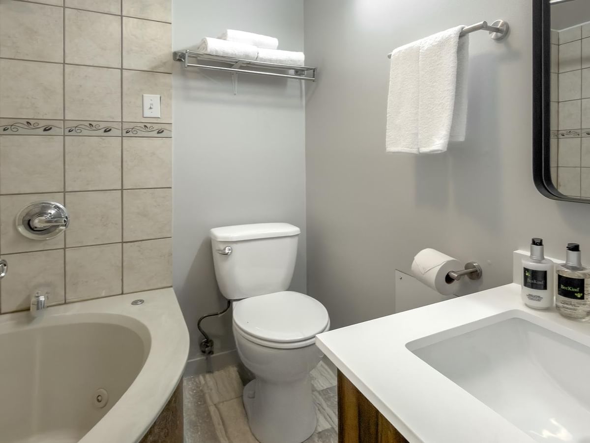Bathroom with a jetted tub and toilet.