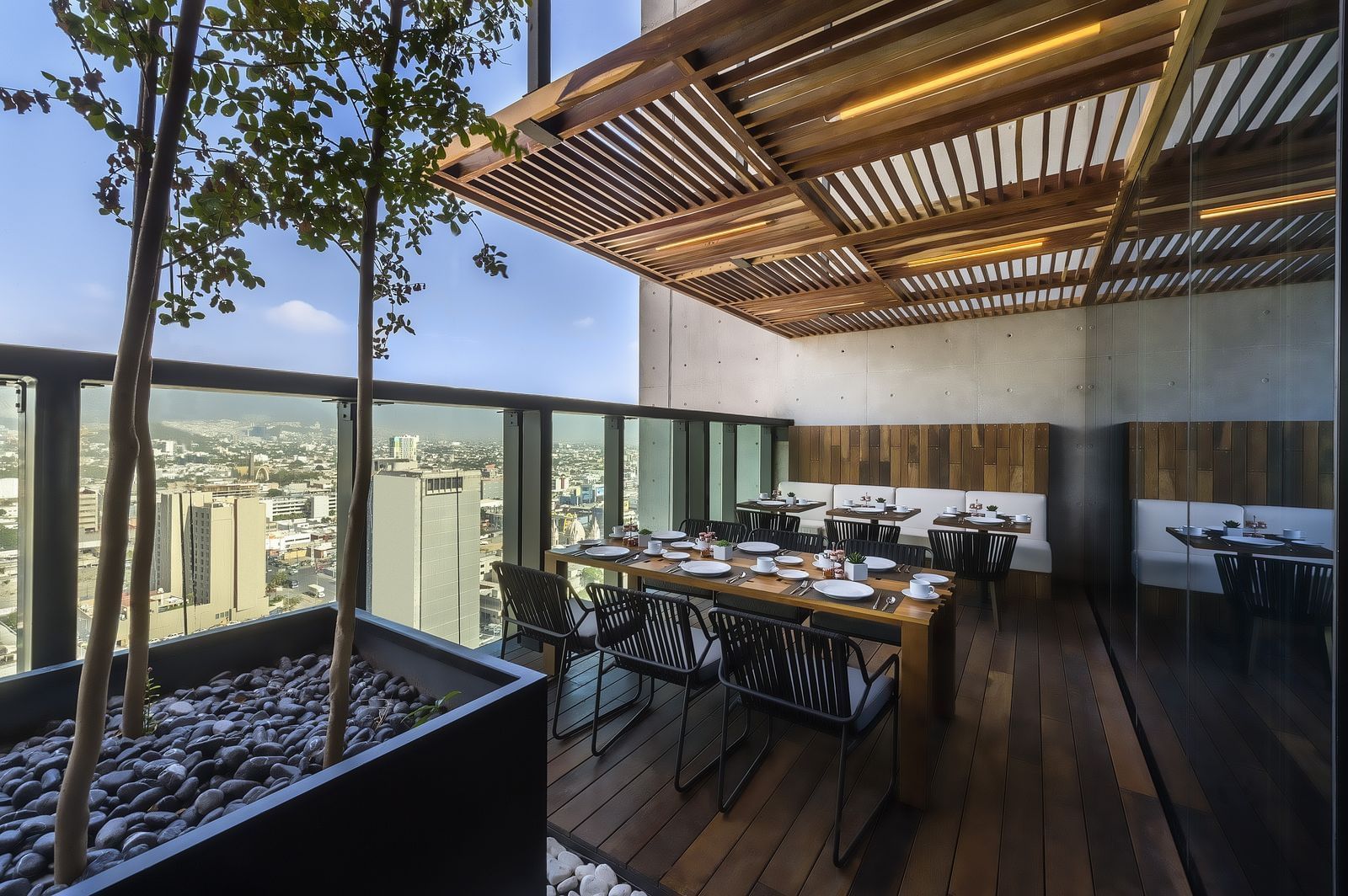 Terrace dining area with a city view at Live Aqua Resorts