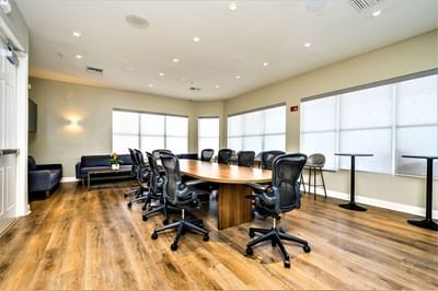 Long conference table surrounded by chairs in a modern room at Vista Cay Resort By Millenium