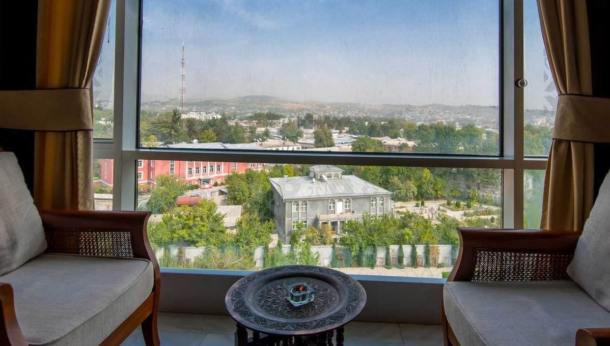 City view of chairs beside window  at Dushanbe Serena Hotel 