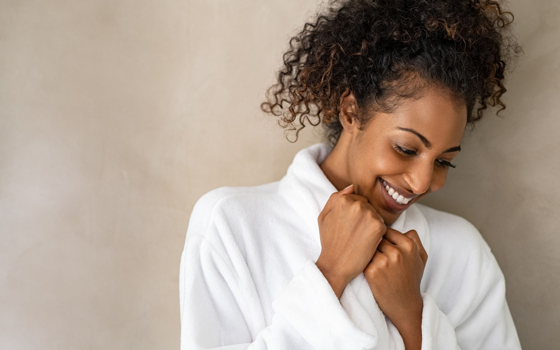 smiling woman in white robe