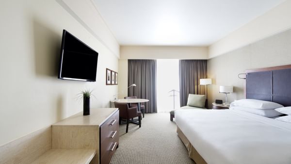 TV & bed in Deluxe Room at Grand Fiesta Americana