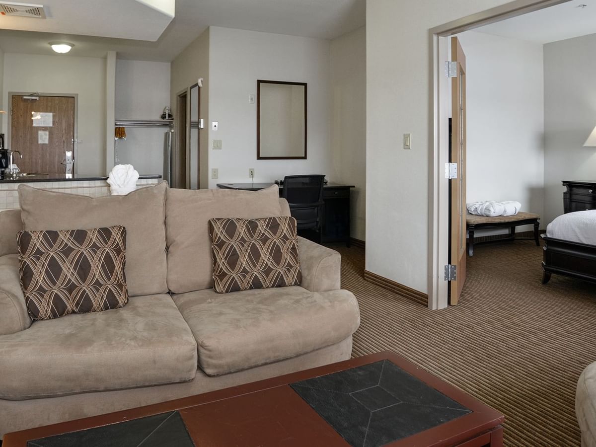 Hotel suite with a separate living room, equipped with a jetted tub