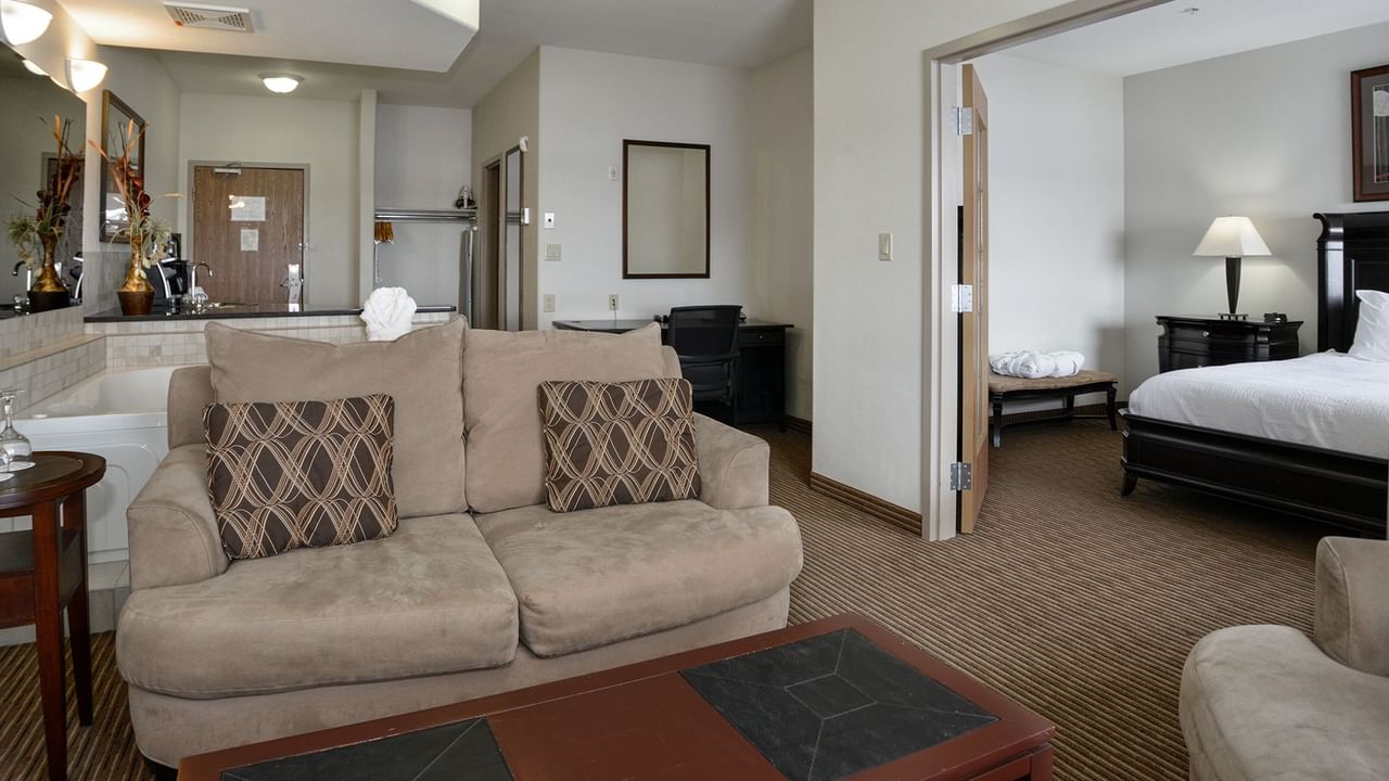 Hotel suite with a separate living room, equipped with a jetted tub