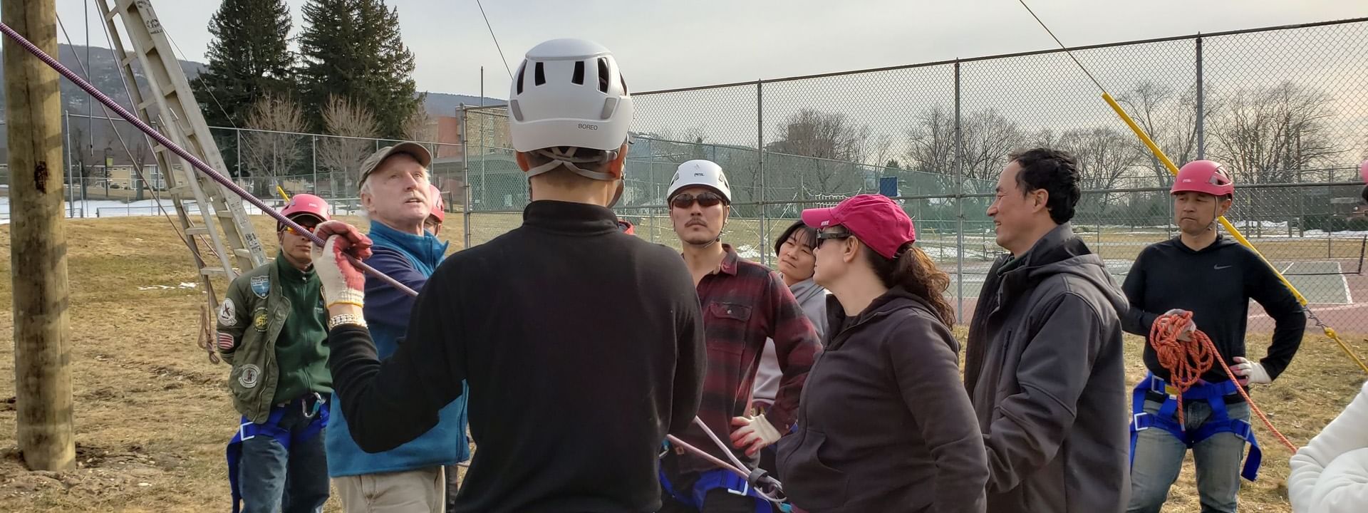 People in harnesses at ropes course