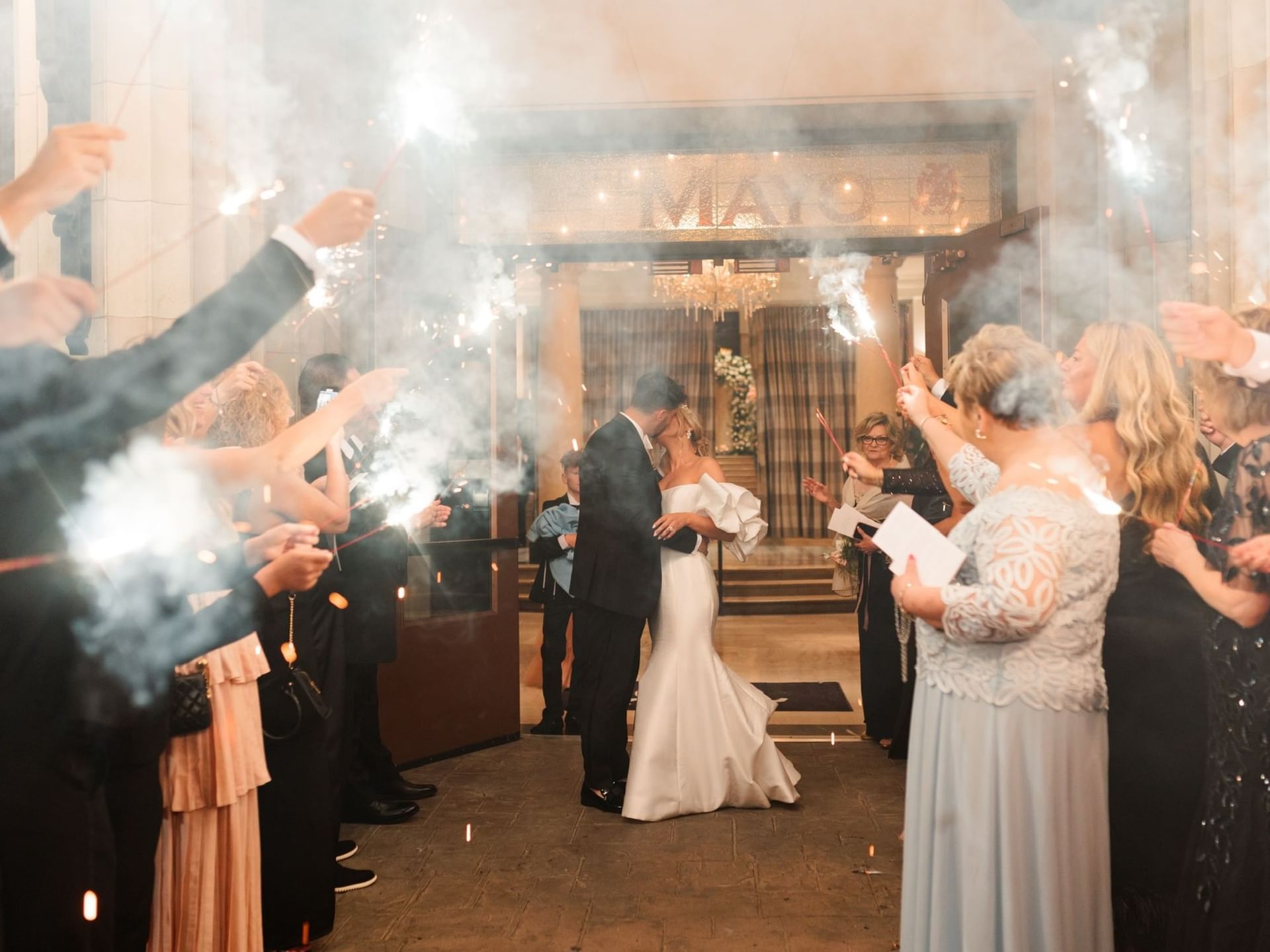 Wedded couple kissing in their ceremony at The Mayo Hotel