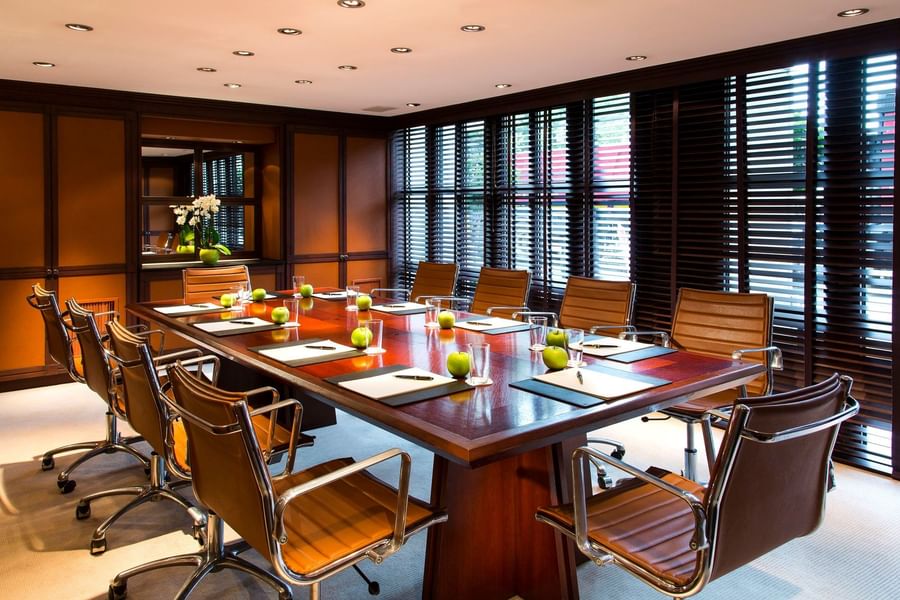 Boardroom table designed for Barsey I meeting room with notepads & pens, and water on the table at Hotel Barsey by Warwick