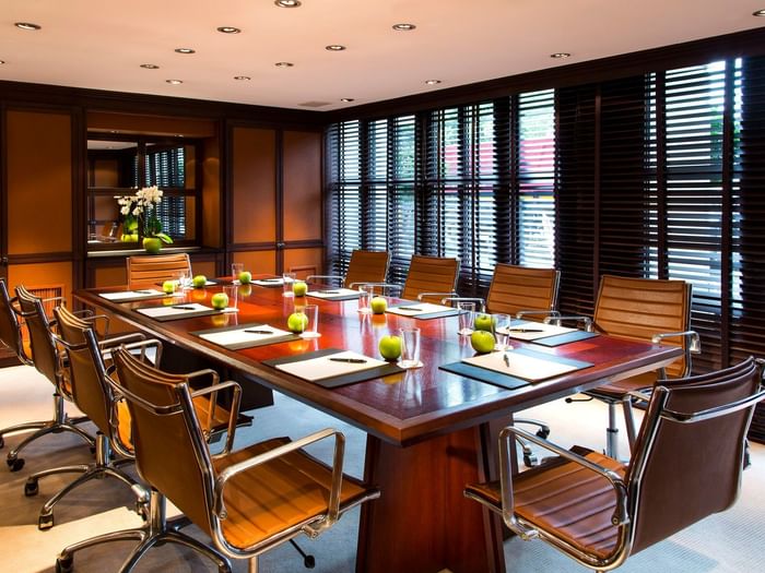 Boardroom table designed for Barsey I meeting room with notepads & pens, and water on the table at Hotel Barsey by Warwick