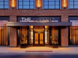 Outdoor hotel entrance with illuminated lights at Godfrey Hotel Detroit