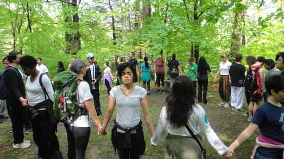 People holding hands at an outdoor activity at Honor's Haven Retreat